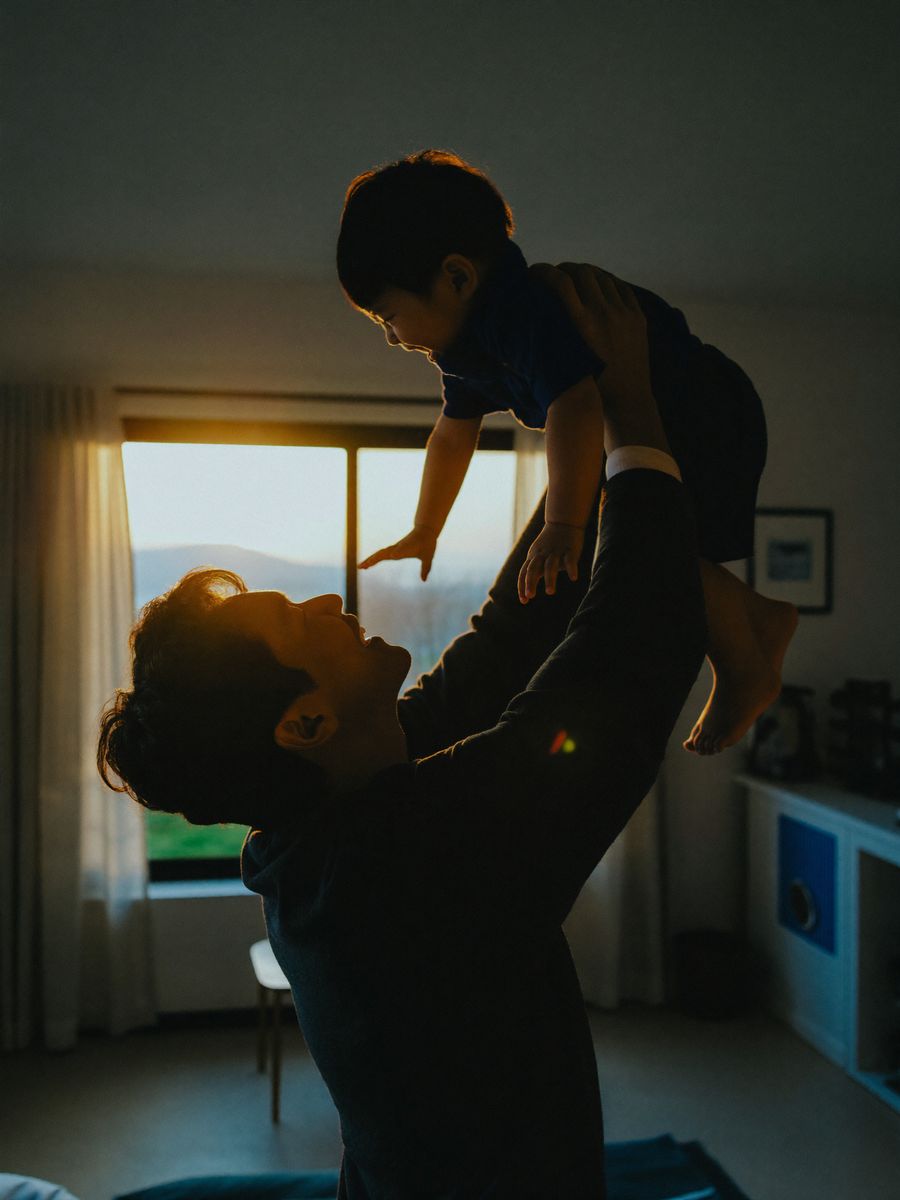 Father laughing with his son at home